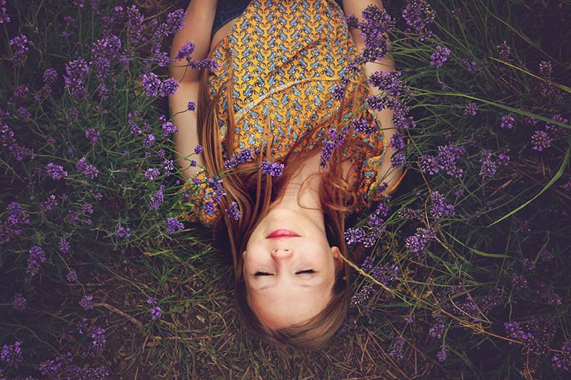 girl laying in purple flowers