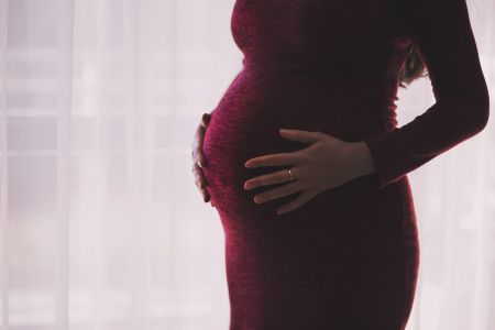 Pregnant women holding stomach