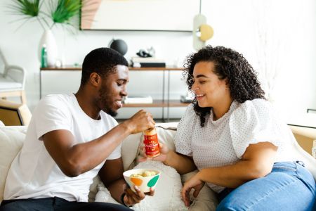 couple sharing snacks in a house
