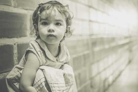 child crouched in hallway