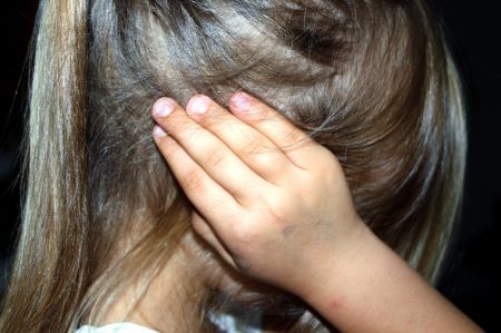 girl covering her ears