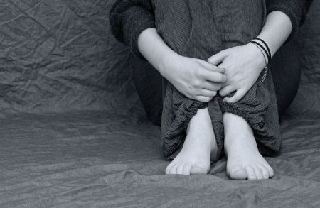 person holding legs on floor