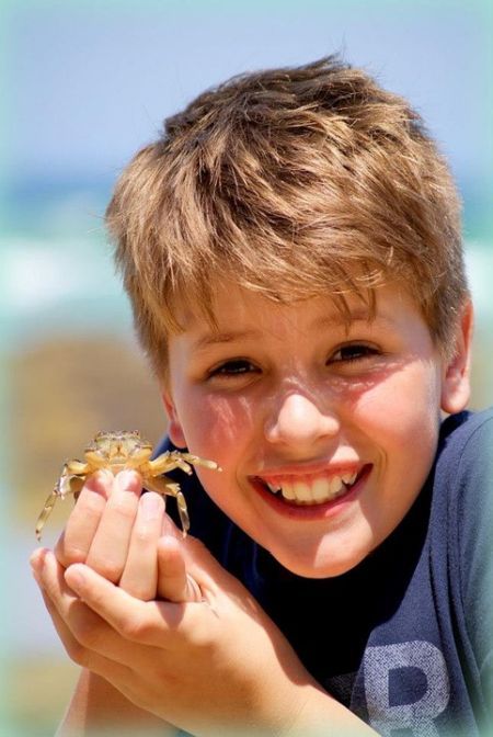 young boy holding crab