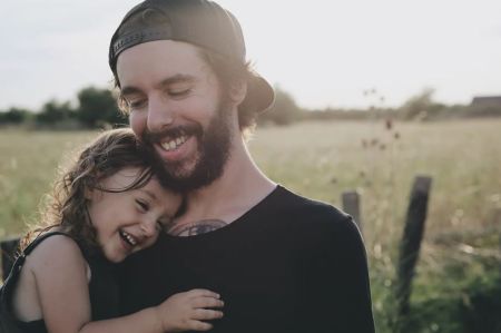 father laughing with daughter