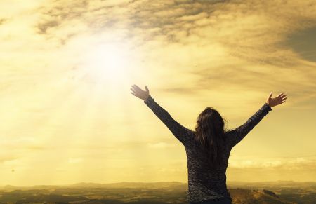 woman holding her arms up