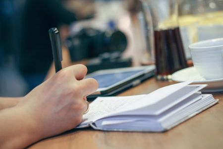 person writing in notebook