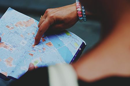 person pointing at map