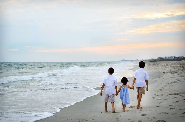 kids walking on beach edge