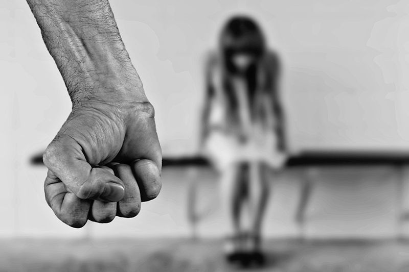 fist with girl in background