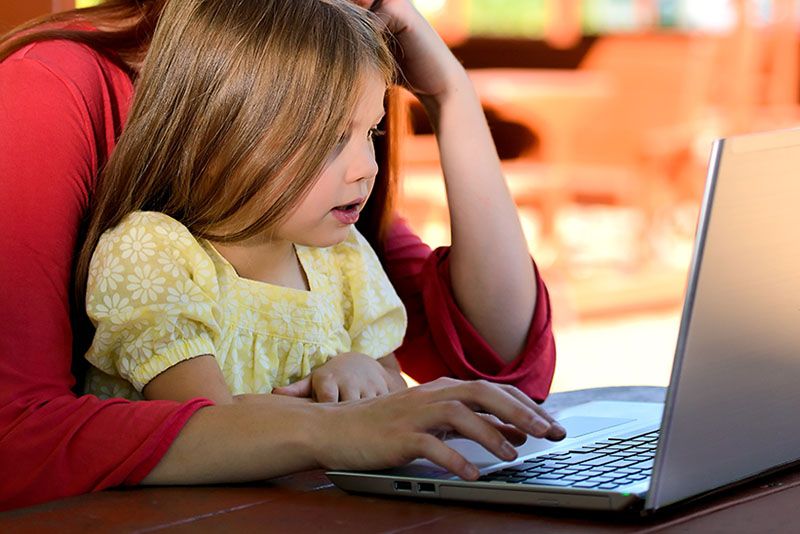 child and mom on computer